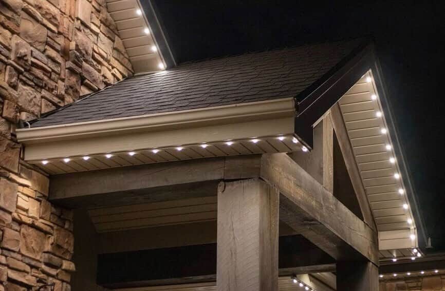 Close up of Ember LED strip tucked into the soffit of a stone timber home